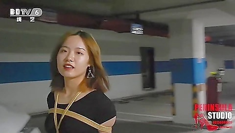 Young Chinese Girl Walks Around Carpark Tied Up Young Chinese Girl Walks Around Carpark Tied Up